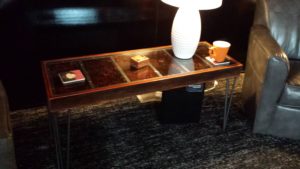 glass topped table with 3 rod hairpin legs