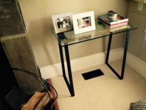 glass topped table with custom metal table legs